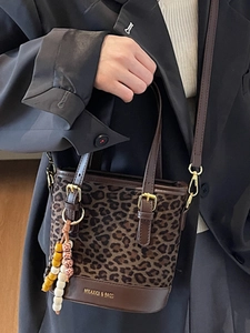 Leopard print bucket bag with brown leather trim and detachable strap by MKAXIQI & BAGS