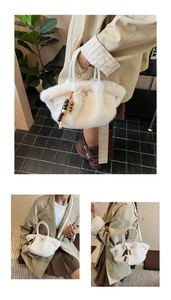 Detail of white faux fur shoulder bag with beaded charm and leather top handle