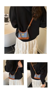 Detailed close-up of quilted denim crossbody bag with brown leather trim and gold chain