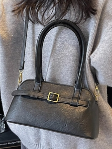 Minimalist black PU leather shoulder bag with gold buckle and textured finish for women