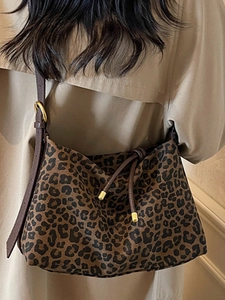 Fashionable leopard print canvas tote bag with drawstring closure and golden hardware