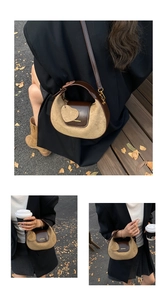 Detail view of vintage crescent crossbody bag with bicolor leather and heart charm