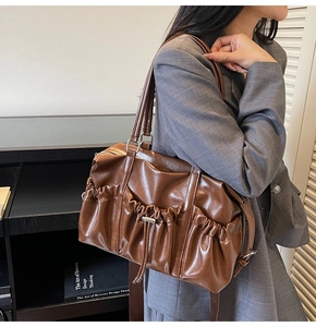 Detail view of brown vintage pleated tote bag showing the soft texture and drawstring design