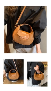 Detail of brown crescent bag showing suede and leather textures with gold hardware
