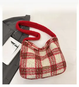 Close-up of red and brown plaid wool tote bag with soft sherpa texture and brand tag