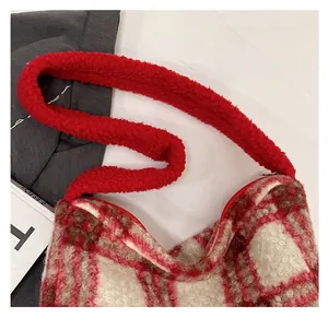Close-up of soft red and white checkered sherpa shoulder bag with plush strap