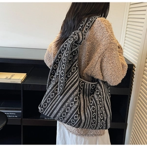 Detail of bohemian canvas tote bag showing retro black and white geometric woven pattern