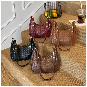 French woven crescent bags in burgundy, black, coffee, and brown on a retro staircase