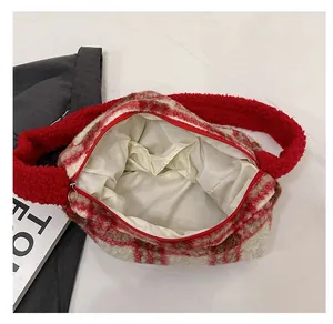 Interior view of red plaid plush tote bag showing inner pocket and satin lining detail