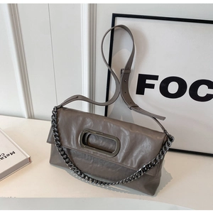 Detailansicht der taupefarbenen Faltenleder-Schultertasche mit Metallkette und Schnalle