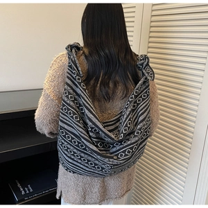 Detail of bohemian canvas tote bag with black and white geometric jacquard pattern