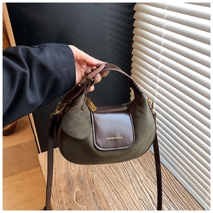 Detail of the green suede and brown leather crescent bag with adjustable strap
