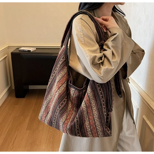 Detail of bohemian canvas tote bag with colorful geometric patterns and knit texture