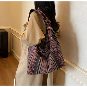 Detail of bohemian striped canvas tote bag showing textured weave and knotted strap