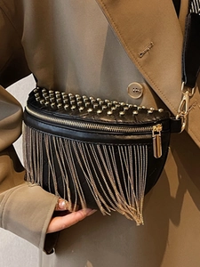 Trendy black crossbody bag with gold studs and metal fringe detail on wide strap