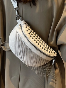 White quilted crossbody bag with black rivets and hanging silver chain tassels