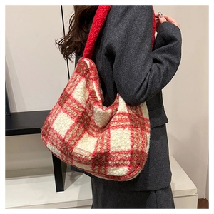 Detail of red and white plaid faux shearling tote bag with leather logo patch