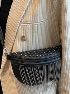 Fashionable black leather waist bag with silver rivets and metallic chain fringe