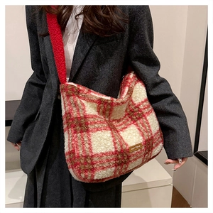 Detail of red and white checkered plush tote bag with a soft shoulder strap