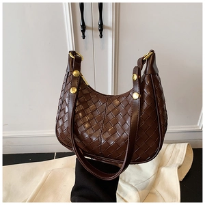 Detailed close-up of dark brown woven hobo bag with elegant golden hardware accents