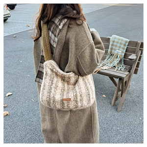 Detailed view of large plush striped tote bag featuring faux shearling texture and our fave label