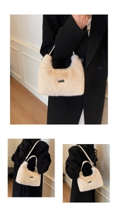 Close-up of fluffy beige plush underarm bag with a metallic JINGPIN logo and slim white strap