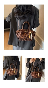 Detail der Handtasche mit Leopardenmuster, Wildledertextur, Perlenquaste und Griffen