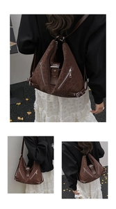 Detailed close-up of brown leopard print texture and silver zipper of this commute bag