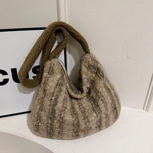 Detail shot of the plush striped wool shoulder bag showing texture and logo label