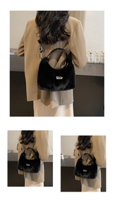 Detail of plush black faux fur shoulder bag with metallic logo and sleek leather strap