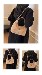 Detail of beige faux fur crescent bag with premium brown leather handle and metal logo