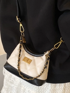 Vintage quilted crossbody bag in beige and black leather with gold metal twist lock