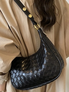 French woven black crescent hobo bag with gold hardware and elegant shoulder strap
