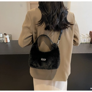 Detail of black plush faux fur crossbody bag with silver JINGPIN logo on the front