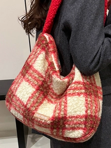 Red and white checkered faux shearling tote bag with a plush texture and leather tag