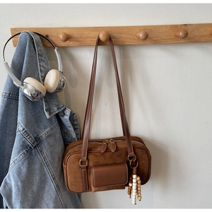 Retro brown suede Boston bag detail with wooden bead charm and thin leather shoulder strap
