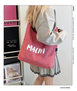 Detail shot of a red and white checkered canvas tote bag with MALIVI letter print
