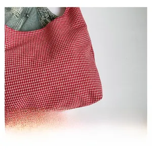 Detail of red and white gingham canvas fabric with premium soft texture for handbag