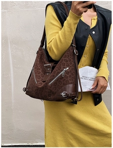 Macro shot of brown leopard print tote bag with faux suede texture and leather corner accents