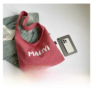 Detailed top view of red and white checkered canvas tote bag with MALIVI letter print