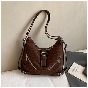 Detail of leopard print hobo bag with silver hardware and faux suede texture finish