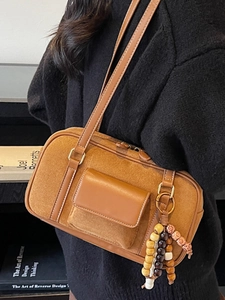 Vintage brown frosted suede Boston bag with tribal bead charm and leather piping