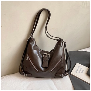 Detail view of dark coffee faux leather backpack with decorative buckle and side zippers