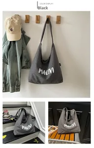 Detailed view of large checkered canvas tote bag with MALINI script print for casual daily use