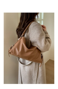 Detail of brown lychee grain faux leather hobo shoulder bag with metal buckle and strap