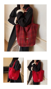 Detailed view of red canvas tote bags with plaid patterns and dog illustration