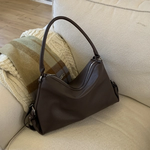Detailed texture of dark brown lychee grain leather on a large capacity hobo bag