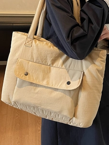 Large beige nylon tote bag with front snap pocket for daily commuting and office work