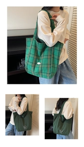 Detailed view of plaid canvas tote and green bag with dog embroidery for daily use
