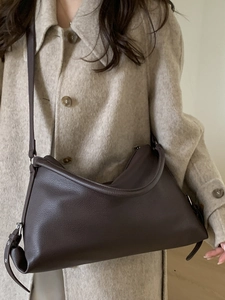 Brown leather crossbody tote bag with adjustable strap and pebble grain texture for women
